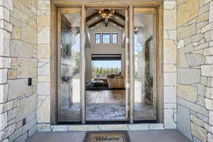 View of exterior entry featuring stone siding