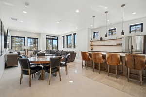 Dining space with recessed lighting, healthy amount of natural light, and bar area