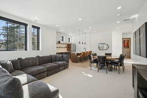Living room with light carpet and recessed lighting