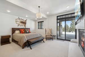 Carpeted bedroom with access to exterior