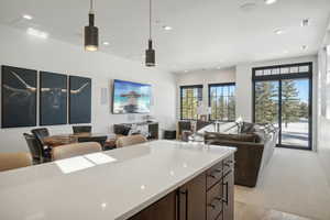 Kitchen featuring dark brown cabinets and hanging light fixtures