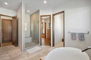 Full bath with a stall shower, recessed lighting, and a soaking tub