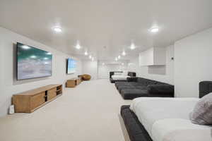 Living area featuring carpet floors and recessed lighting