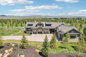 Modern farmhouse style home with a standing seam roof, stone siding, a mountain view, and metal roof