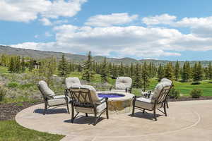 View of patio / terrace with a mountain view and an outdoor fire pit