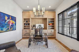 Home office featuring a chandelier, wood finished floors, baseboards, and recessed lighting