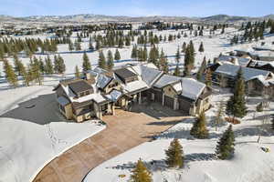 Snowy aerial view with a mountain view and a residential view