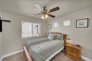 Carpeted bedroom with ceiling fan