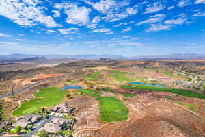 Birds eye view of property featuring a water and mountain view