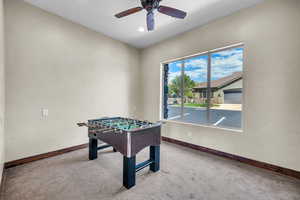 Game room featuring ceiling fan and carpet floors