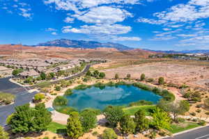 Birds eye view of property featuring a water and mountain view