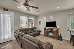 Living room with ceiling fan and light tile patterned floors