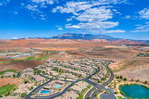 Birds eye view of property with a water and mountain view