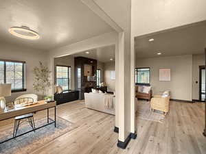 Living room with a textured ceiling and light wood-type flooring