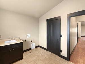 Laundry room with washer hookup, sink, cabinets, and hookup for an electric dryer