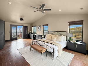 Bedroom with ceiling fan, lofted ceiling, access to exterior, and hardwood / wood-style floors