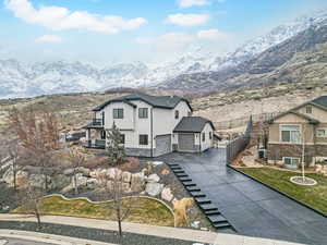 Exterior space with a front yard, central AC, and a mountain view