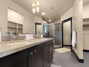 Bathroom with tile patterned floors, walk in shower, and vanity