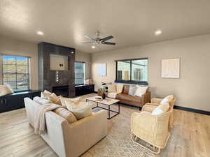 Living room featuring ceiling fan and light wood-type flooring