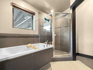 Bathroom featuring separate shower and tub and tile patterned flooring