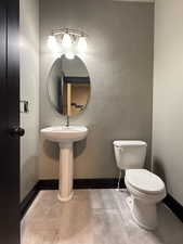 Bathroom featuring tile patterned floors and toilet