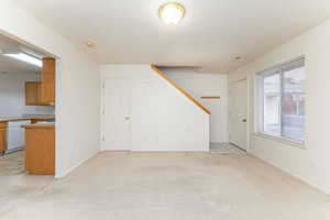 Unfurnished living room with light colored carpet