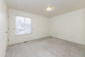 Empty room with light colored carpet