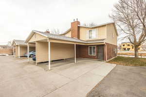 Rear view of property featuring a carport