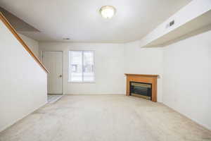 Unfurnished living room with light colored carpet