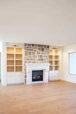 Unfurnished living room featuring light hardwood / wood-style floors and a fireplace