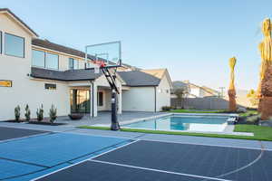 View of sport court featuring a fenced in pool