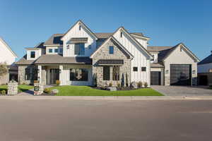 View of front facade with a front lawn and a garage