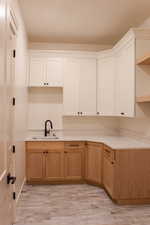 Kitchen featuring light wood-type flooring and sink