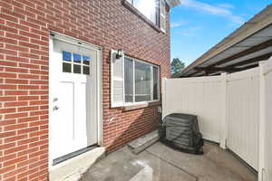 Property entrance featuring a patio area