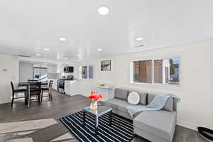 Living room with dark hardwood / wood-style floors