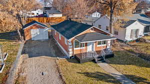 View of front of property with a front yard and a storage shed