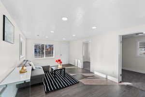 Living area with a textured ceiling and dark hardwood / wood-style floors