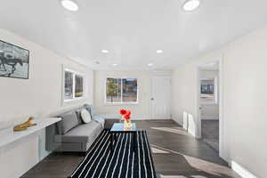 Living room featuring a textured ceiling and dark hardwood / wood-style floors