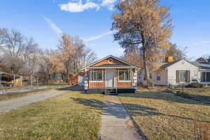 Bungalow featuring a porch and a front yard