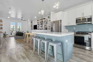 Contrasting blue kitchen island with bar