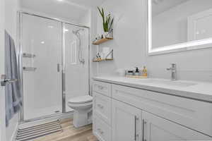 En-suite bathroom featuring a shower & one sink vanity