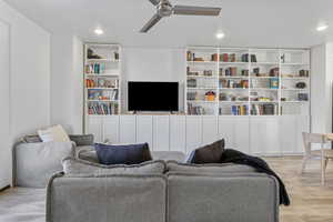 Living room featuring bookshelves and cabinets