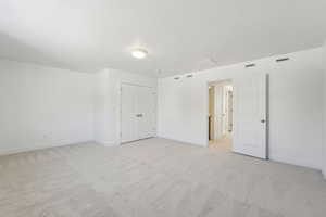 Carpeted empty room with a textured ceiling