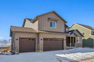 View of front facade with a garage and a mountain view