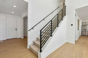 Stairs with hardwood / wood-style flooring