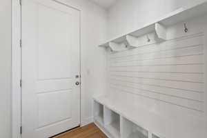 Mudroom with light hardwood / wood-style floors