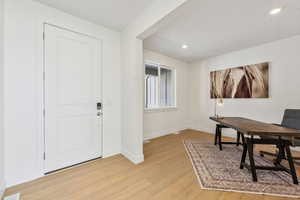 Office space with light hardwood / wood-style flooring