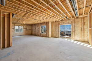 Misc room with concrete flooring and plenty of natural light