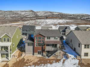 Snowy aerial view featuring a mountain view