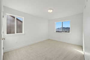 Unfurnished room with light colored carpet